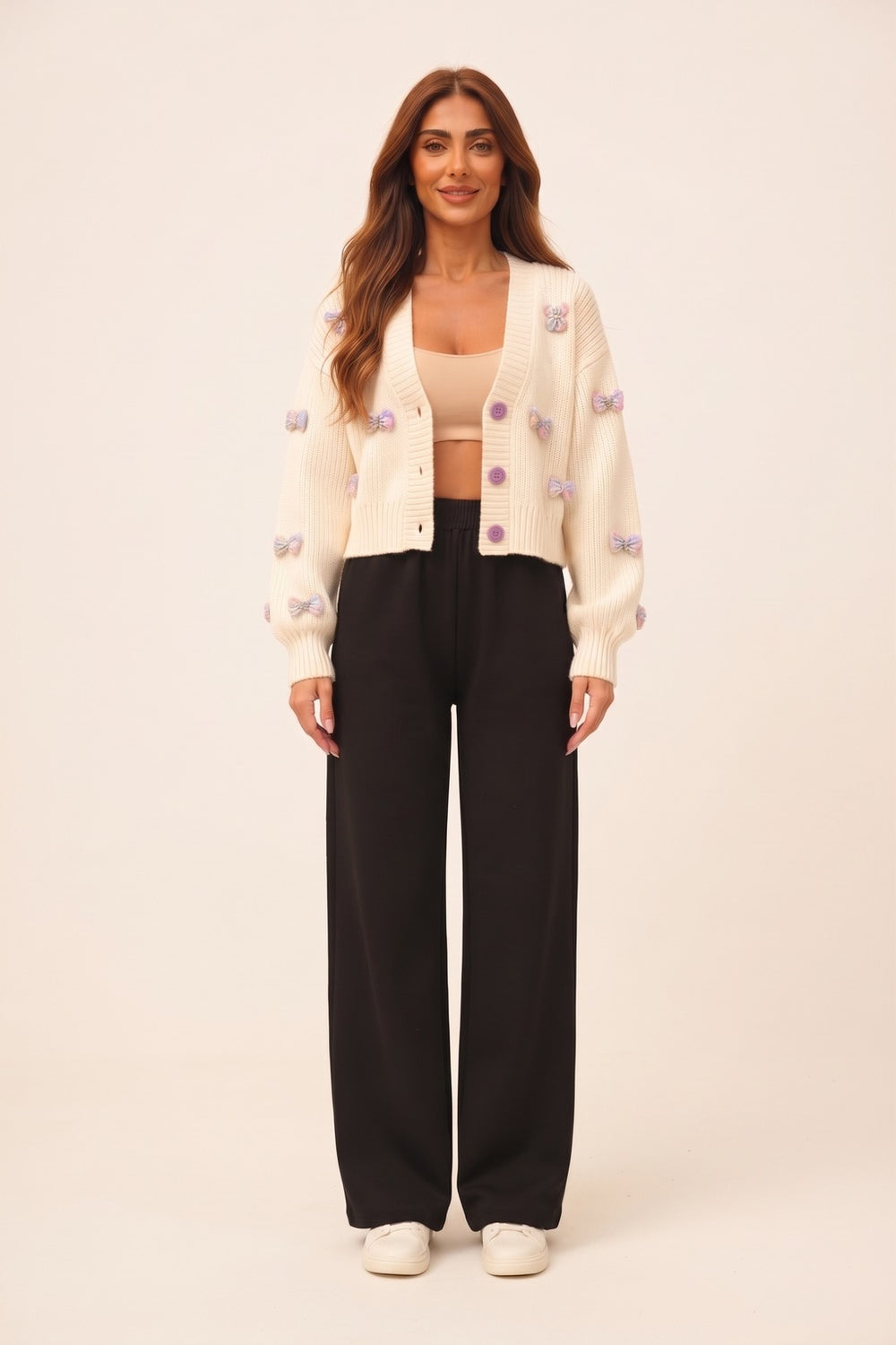 Women's cream cropped cardigan and black wide leg pants set – 3D bow appliqué knit cardigan, on model | Topline Lebanon