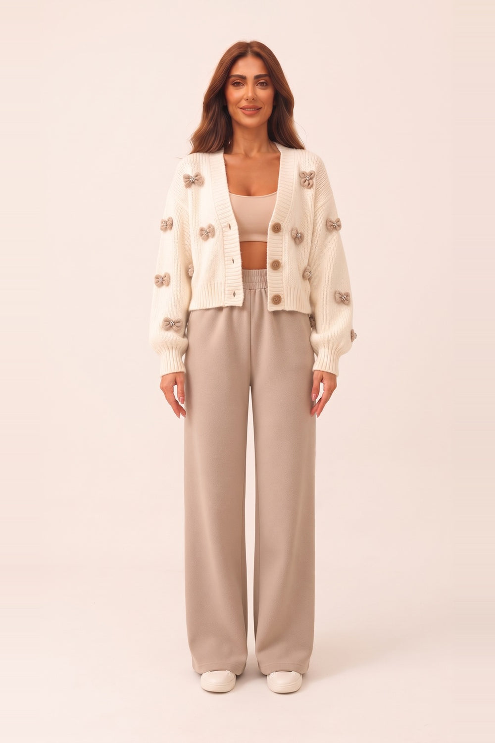 Women's cream cropped cardigan and beige wide leg pants set – 3D bow appliqué knit cardigan, on model | Topline Lebanon