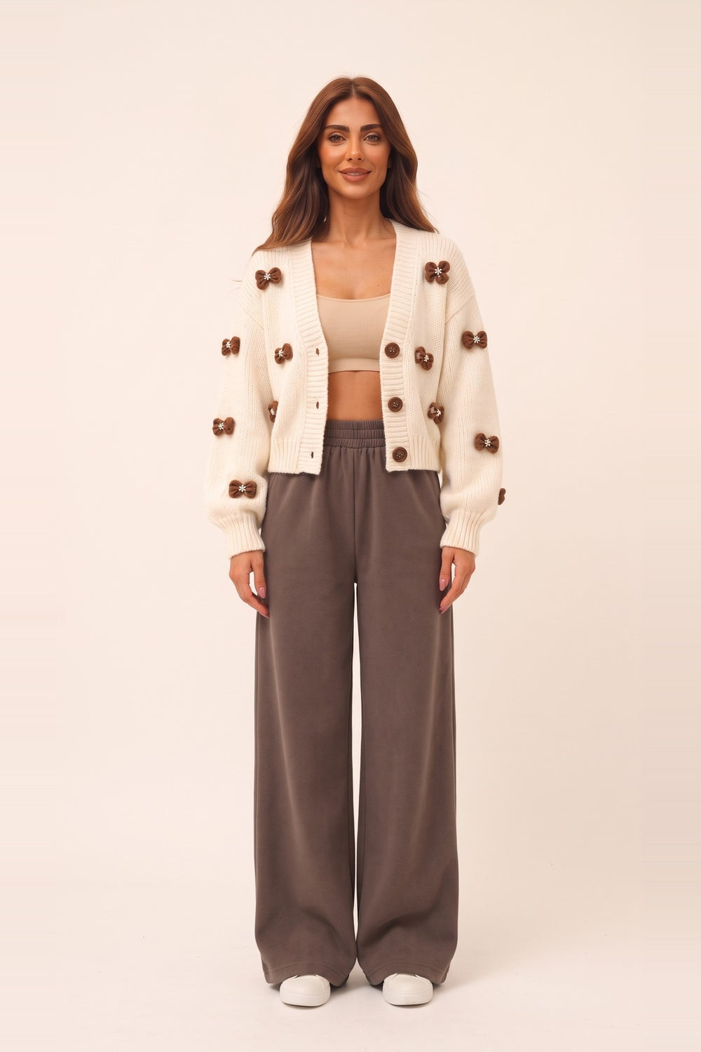 Women's cream cropped cardigan and mocha wide leg pants set – 3D bow appliqué knit cardigan, on model | Topline Lebanon