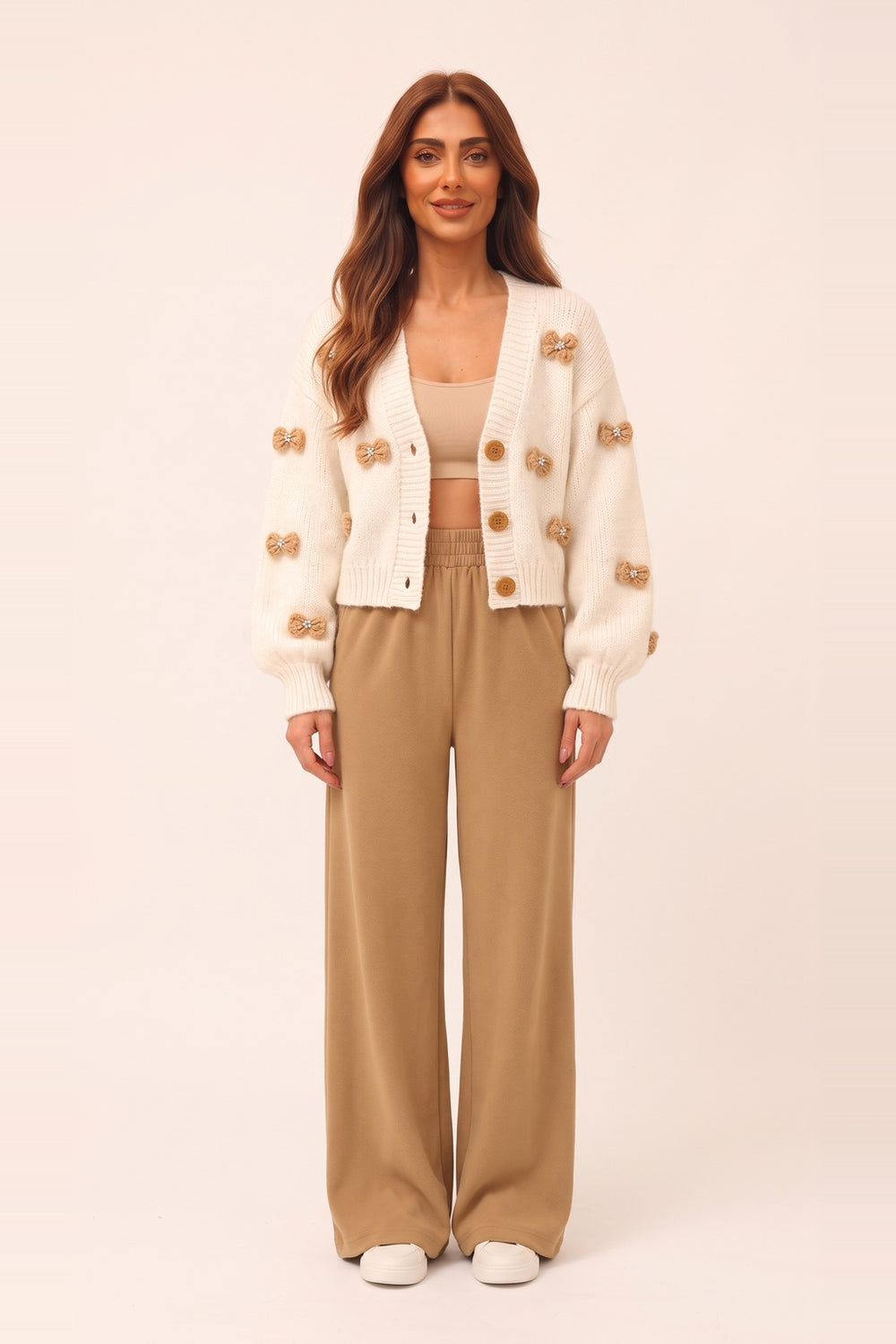 Women's cream cropped cardigan and camel wide leg pants set – 3D bow appliqué knit cardigan, on model | Topline Lebanon