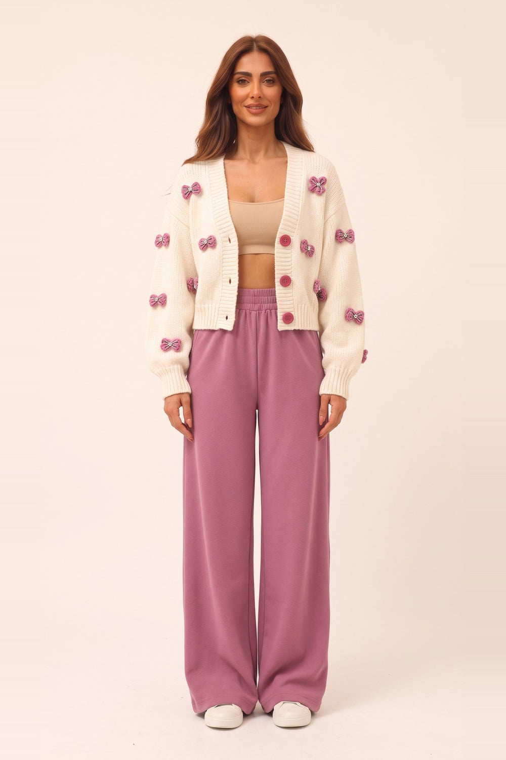 Women's cream cropped cardigan and pink wide leg pants set – 3D bow appliqué knit cardigan, on model | Topline Lebanon