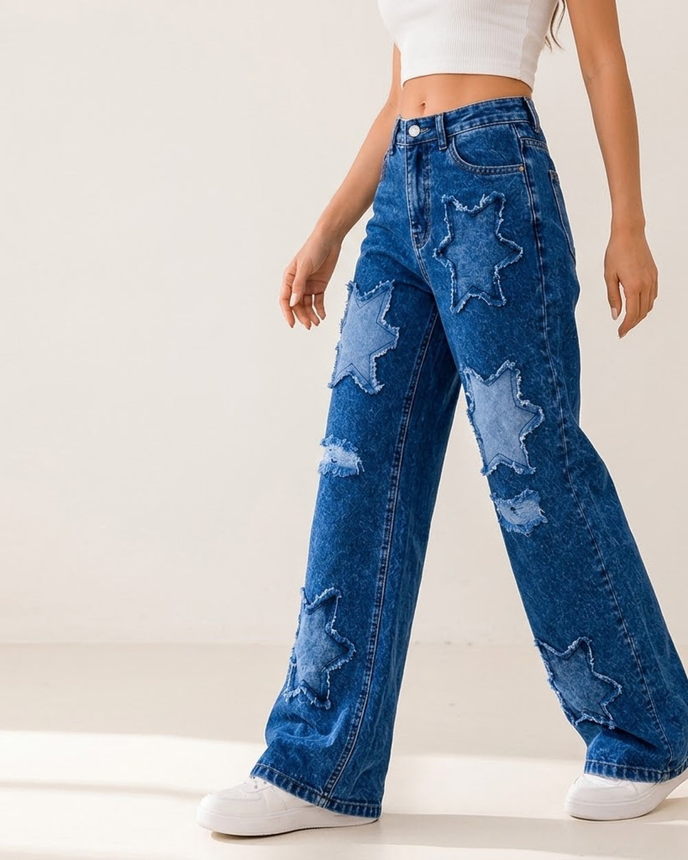 Women's medium blue star patch wide-leg jeans on model