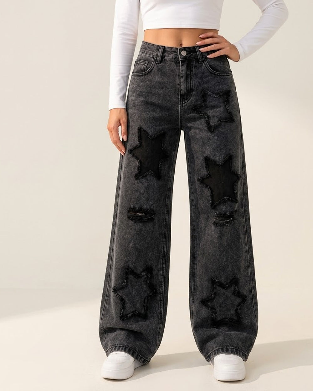 Women's washed black star patch wide-leg jeans on model