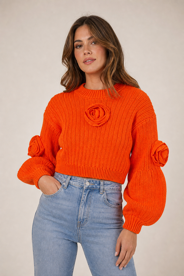 Orange rosette knit sweater on model