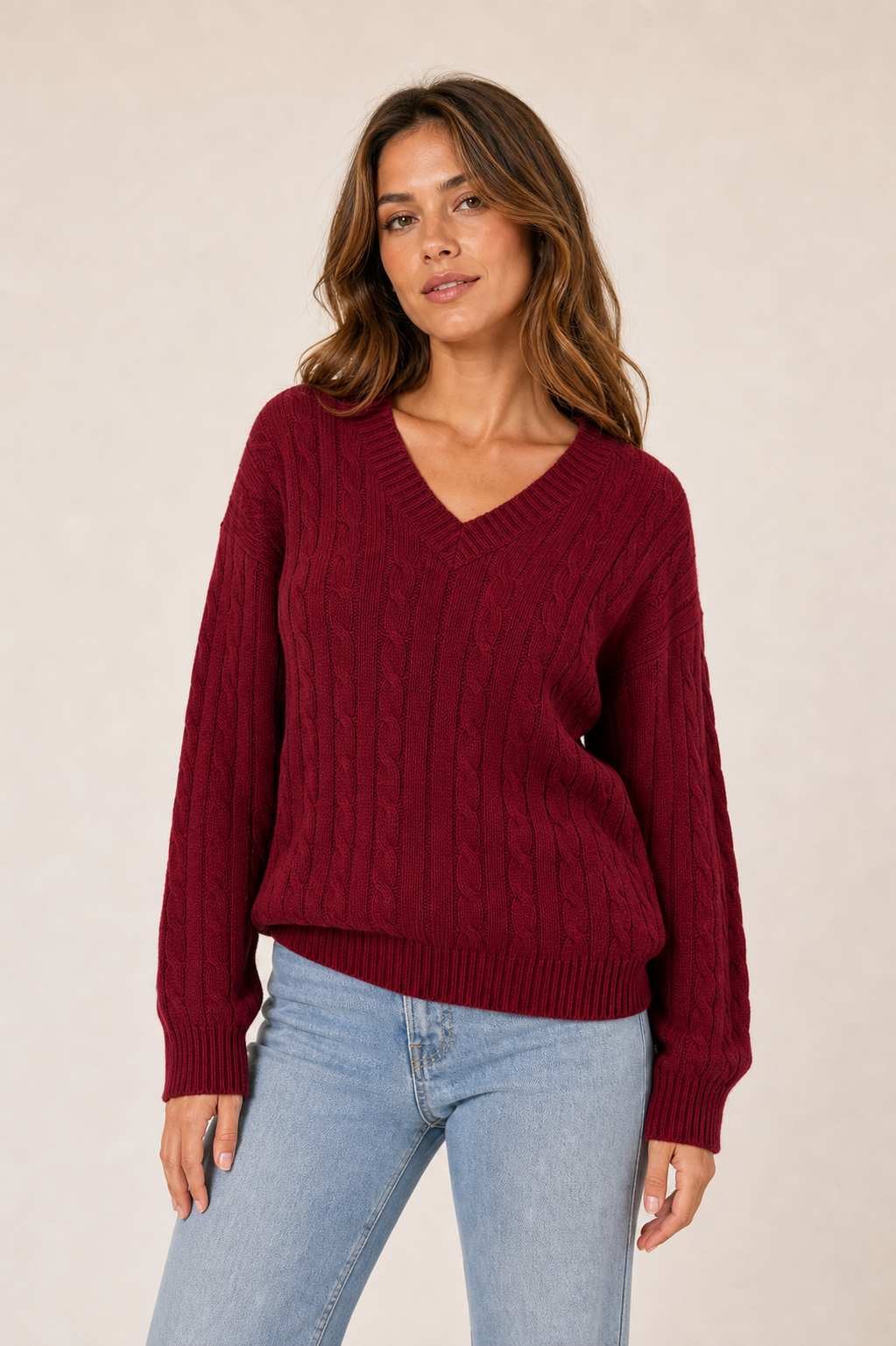 Dark red V-neck cable sweater on model